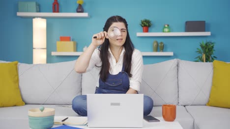 Woman-looking-at-camera-with-magnifying-glass.